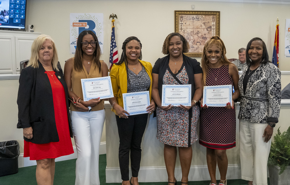 Dr. Tonore, Precious Ivy, Jennifer London, Alicia Wright, Essence Evans, Dr. Lennie Little are standing and smiling in the Vicksburg Warren School District's Board Room with certificates.