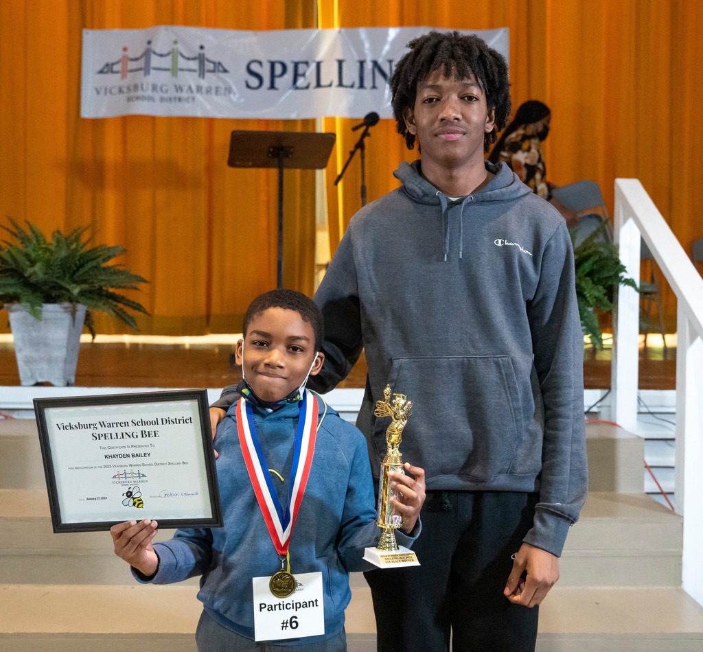VWSD's Spelling Bee winner, Khayden Bailey, poses for a photo with awards and another student
